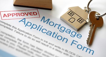 Fannie Mae’s Secret ‘Blacklist’ of Properties Approved Mortgage loan application with house key and rubber stamp