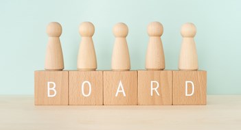 Amending Your Governing Documents BOARD; Wooden blocks with "BOARD" text of concept and human toys.