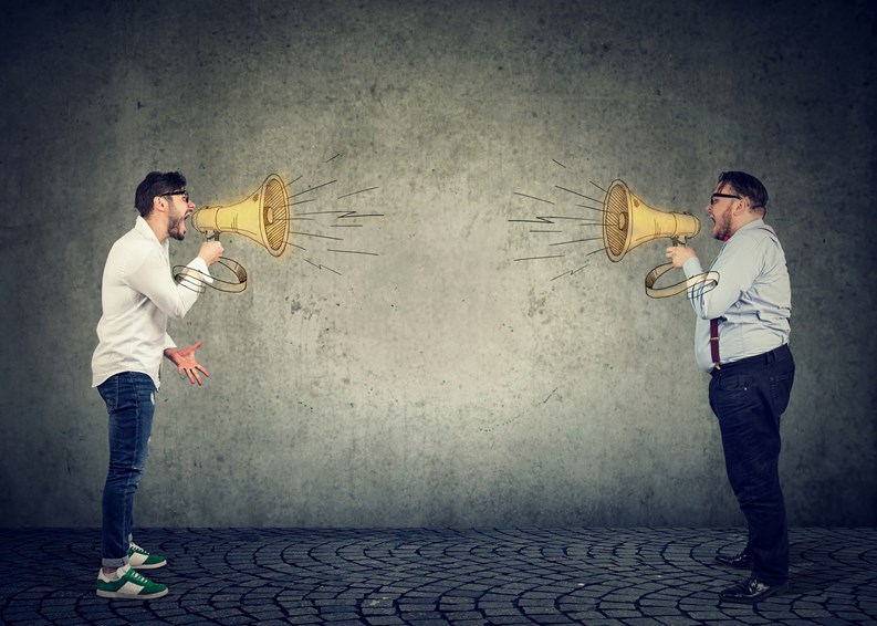 Businessmen screaming into a megaphone at each other having an angry debate