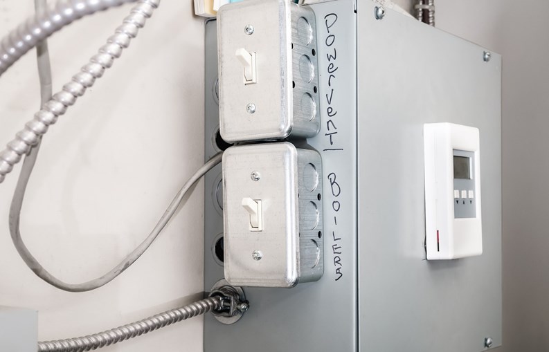 On off power switch for emergency repair or trouble shooting problem with hot water heating system. Selective focus.